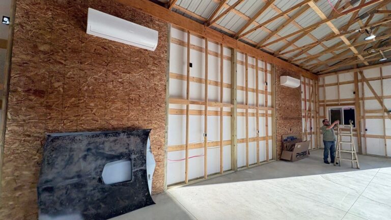 Pole barn walls being insulated with spray foam, with a crew member at work, Southeast Michigan