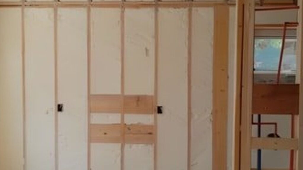 Finished spray foam insulated commercial building wall