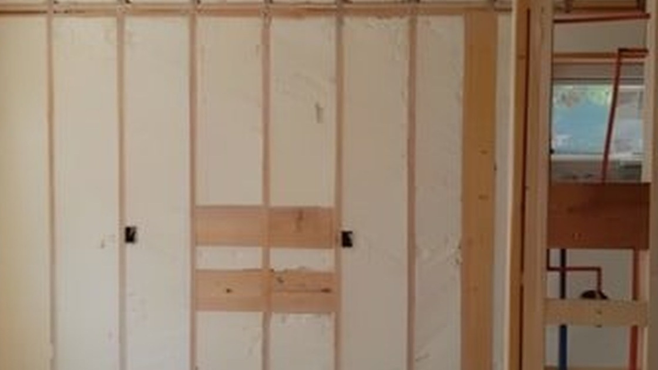 Finished spray foam insulated commercial building wall