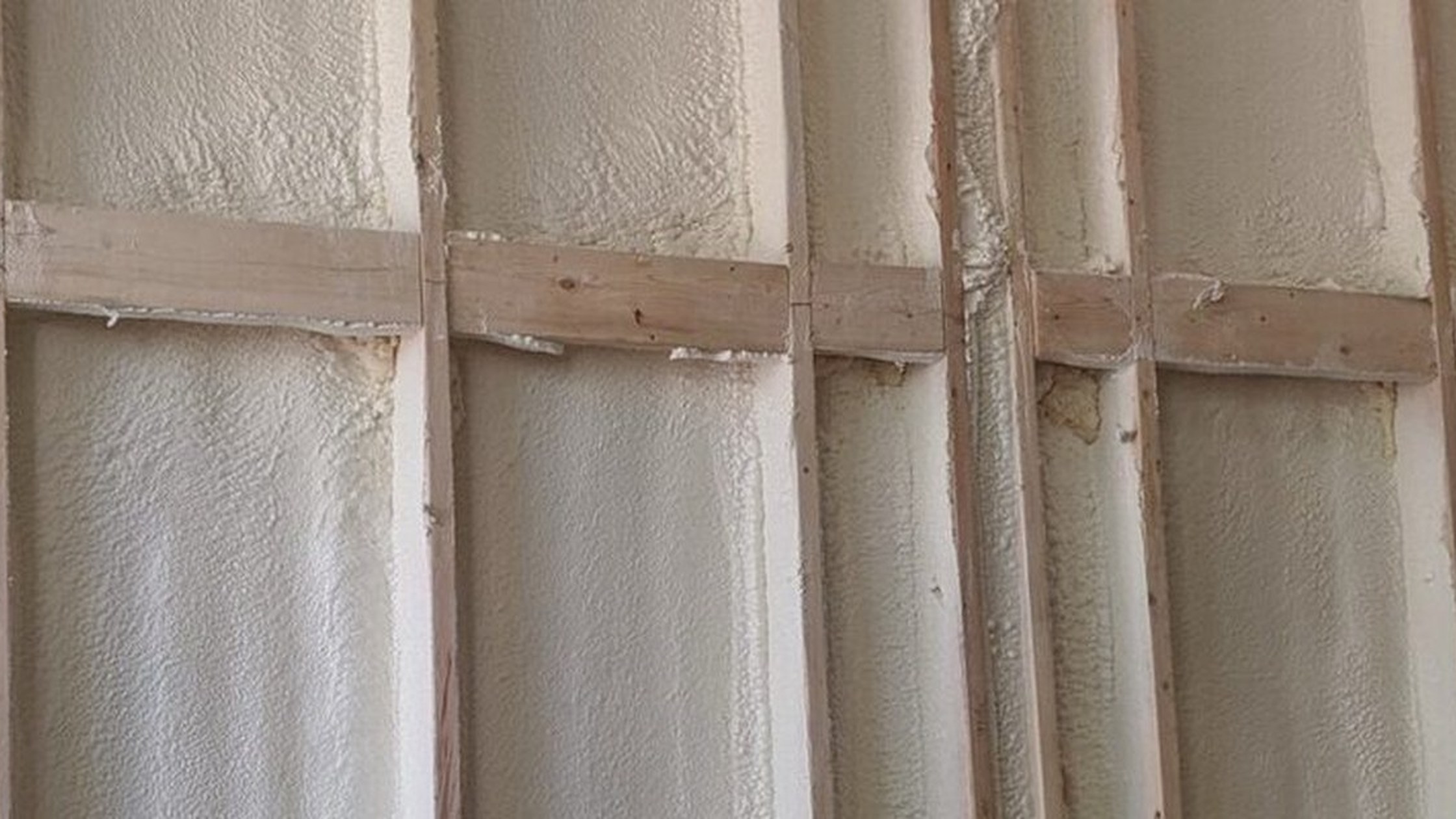 Closed-cell spray foam applied between commercial wall studs