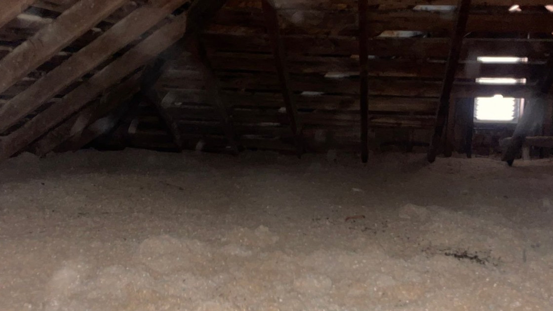 Blown-in insulation across a Michigan home attic floor